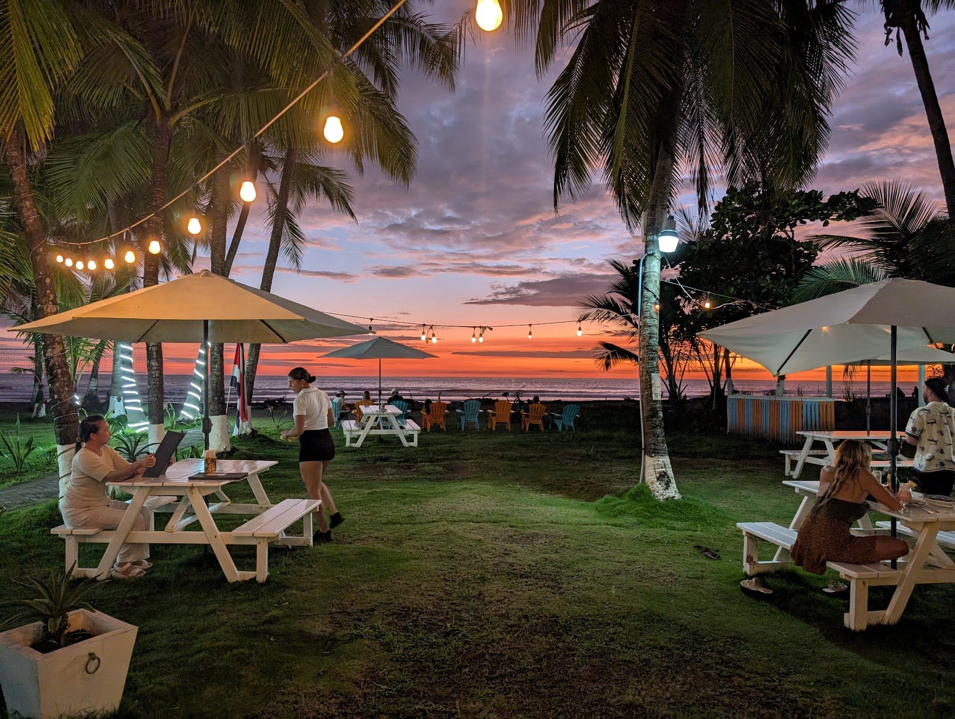 Beachfront tables at sunset at Sea Salt, Hotel Jaco
